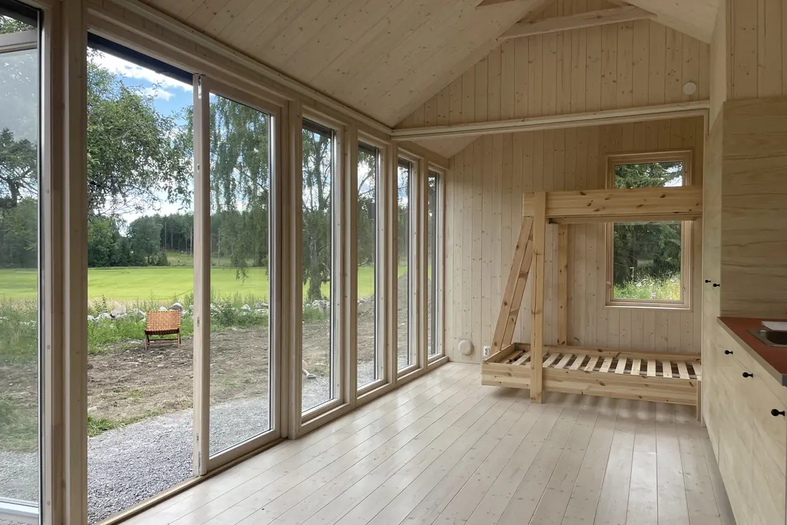 Interiör med våningssäng och stort fönster